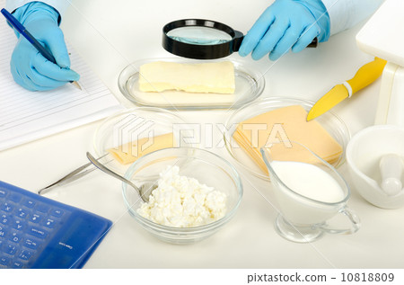 Hands inspecting butter in phytocontrol laboratory 10818809
