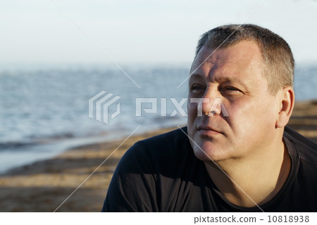 Handsome middle-aged man thinking at the beach 10818938