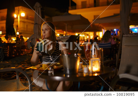 Woman enjoying a drink in a pub or restaurant Woman enjoying a drink in a pub or restaurant 10819095