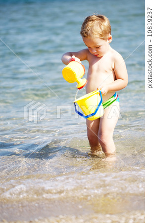 Adorable little boy playing in the sea 10819237