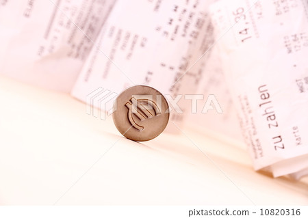 Euro symbol rolled down bills in background 10820316