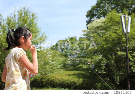 Girls blowing soap bubbles Girls blowing soap bubbles 10821163