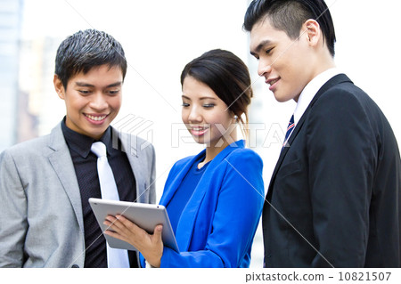 Three business office worker looking at tablet 10821507