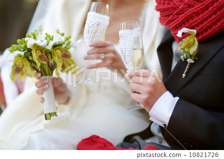 Bride and groom holding champagne glasses Bride and groom holding champagne glasses 10821726