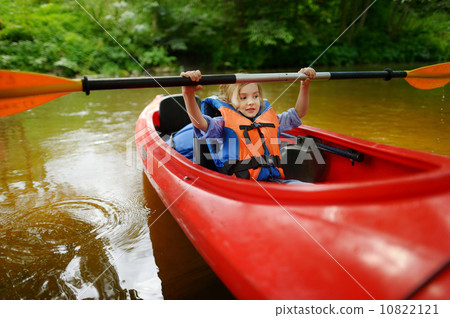 Happy little girl on a kayak on a river 10822121
