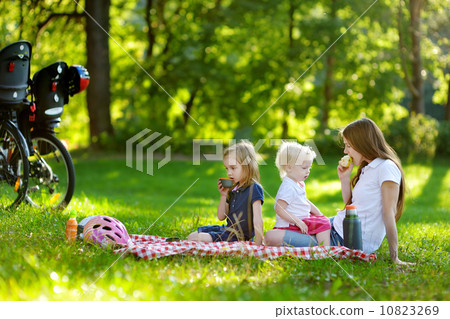 Young mother and her daughters having a picnic 10823269