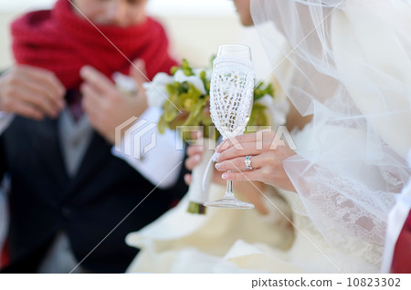 Bride is holding a glass of champagne Bride is holding a glass of champagne 10823302