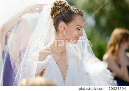 The beautiful bride outdoors before wedding The beautiful bride outdoors before wedding 10823304