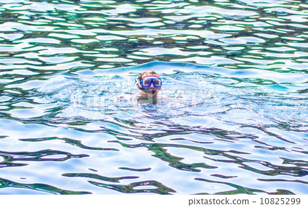 Young man snorkeling in blue sea 10825299