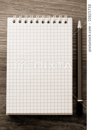 checked notebook on wood checked notebook on wood 10825738