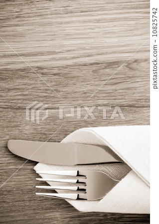 knife and fork at napkin on wood knife and fork at napkin on wood 10825742