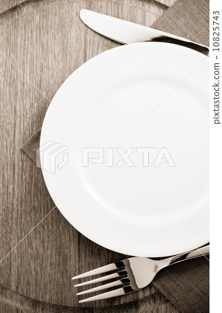 plate, knife and fork  at cutting board 10825743