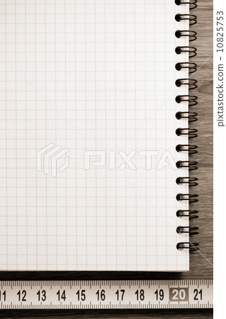 checked notebook on wood 10825753