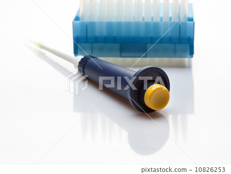 Laboratory pipet in front of disposable tips pack Laboratory pipet in front of disposable tips pack 10826253
