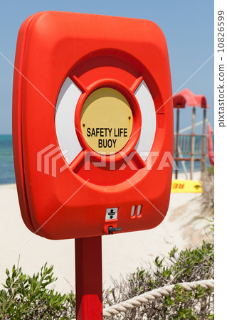 Safety life buoy in plastic case stand on the beach 10826599