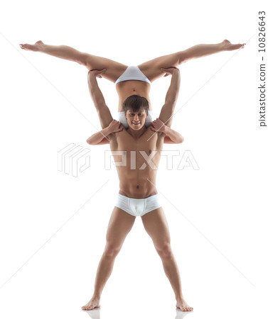 Smiling muscular acrobat holds partner Smiling muscular acrobat holds partner 10826643