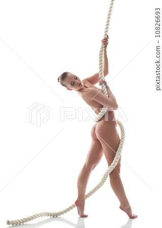 Pretty nude model posing with rope in studio Pretty nude model posing with rope in studio 10826693