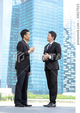 Two successful entrepreneur business men meeting in front of glass office building Two successful entrepreneur business men meeting in front of glass office building 10827023