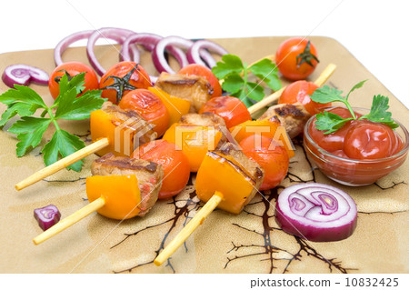 kebab with vegetables and greens on a plate closeup. kebab with vegetables and greens on a plate closeup. 10832425