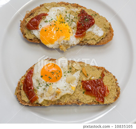 Closeup of Spanish Tapa with Fried egg and dry tomato Closeup of Spanish Tapa with Fried egg and dry tomato 10835105