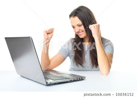 Young woman having success online on her laptop Young woman having success online on her laptop 10836152