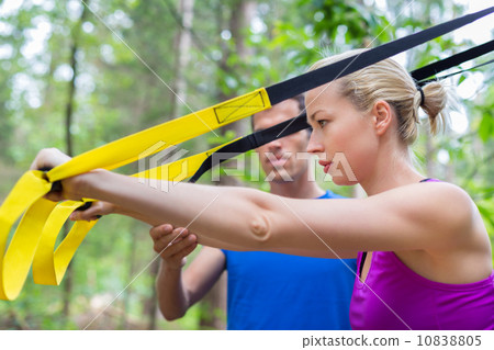 Training with fitness straps outdoors. Training with fitness straps outdoors. 10838805