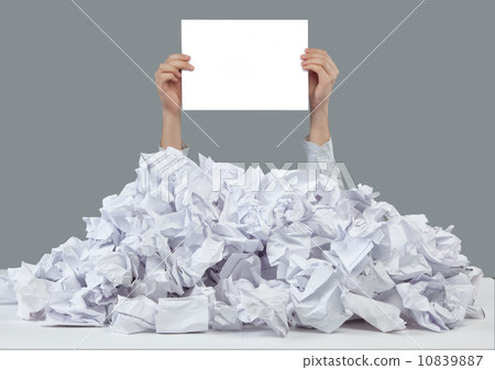 Hands with empty paper reaches out from big heap of crumpled papers 10839887