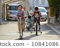 Three friends who enjoy playing with the vehicle 10841086