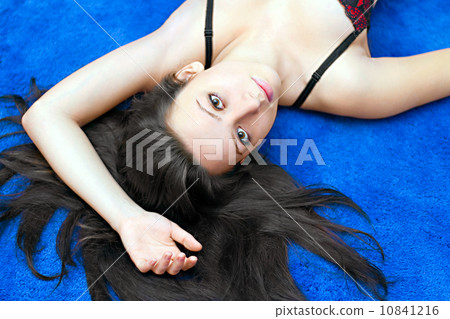 portrait of a young girl on blue background 10841216