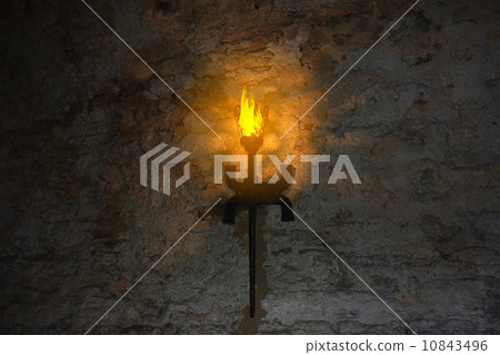 torch on the wall of an old castle 10843496