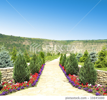 Nice stone walkway from garden in the far Nice stone walkway from garden in the far 10845880