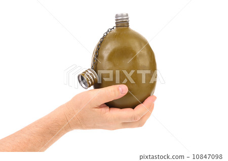 Hand holds old army canteen. 10847098