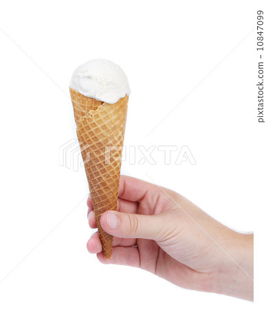 Hand holds cone vanille ice cream. Hand holds cone vanille ice cream. 10847099
