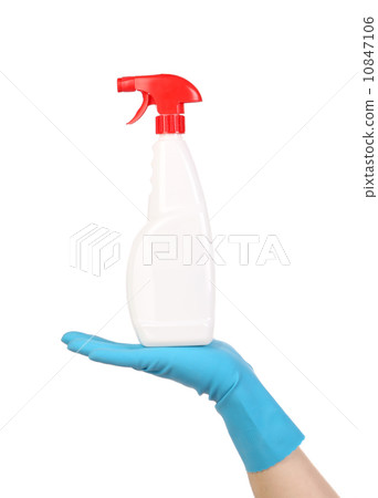 Hand in glove holding white plastic spray bottle Hand in glove holding white plastic spray bottle 10847106