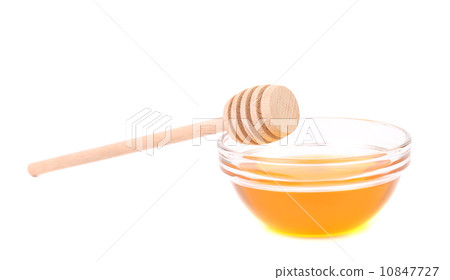 Bee honey with wooden dipper 10847727