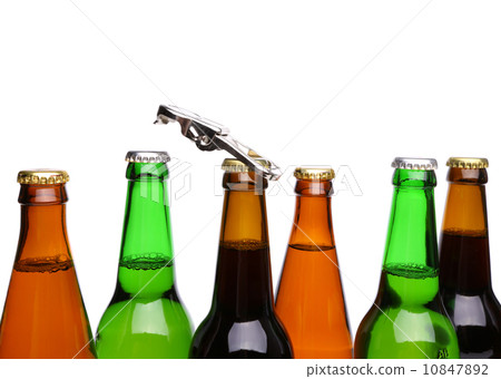 Top bottles of beer and a opener. 10847892