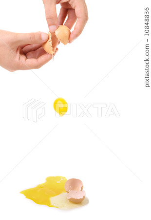 Man hands broke egg falling down. 10848836