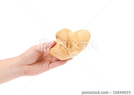Hand holds striped fresh croissant. 10849035