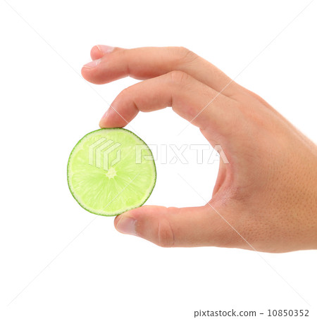 Slice Of Lime In A Hand. White Background. 10850352