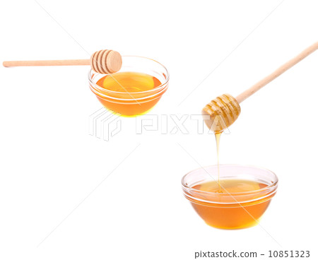 Two bowls with honey and wooden dippers 10851323