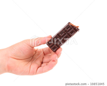 Hand holds chocolate bar with filling. 10851845
