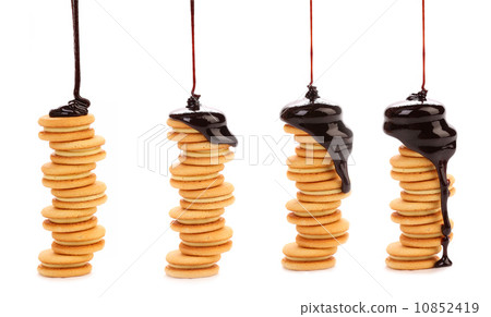 Chocolate dripping on cookies. 10852419