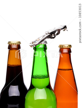 Threee bottles of beer and a opener 10853013
