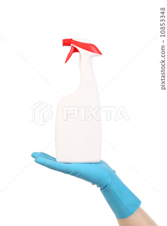 Hand in glove holding white plastic spray bottle Hand in glove holding white plastic spray bottle 10853348