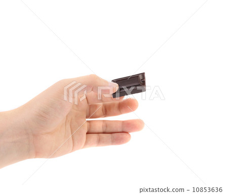 Hand holds chocolate bar. 10853636