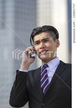 Young Asian businessman with mobile phone Young Asian businessman with mobile phone 10865737