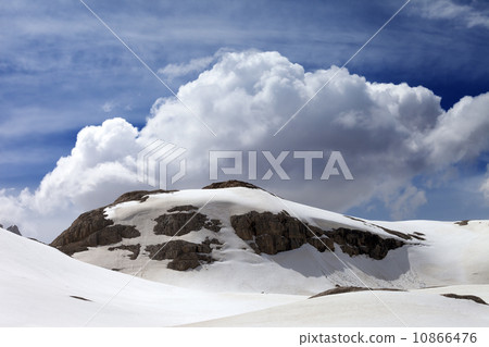 Rocks with snow cornice 10866476