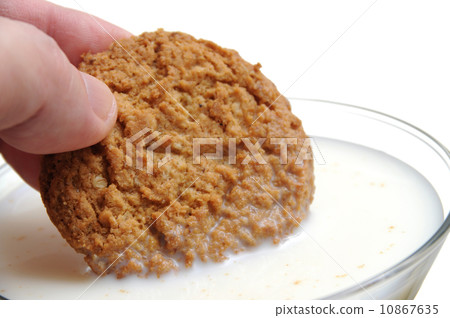 Eating cookie with milk 10867635