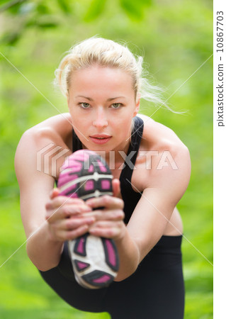 Lady practicing yoga in the nature. 10867703