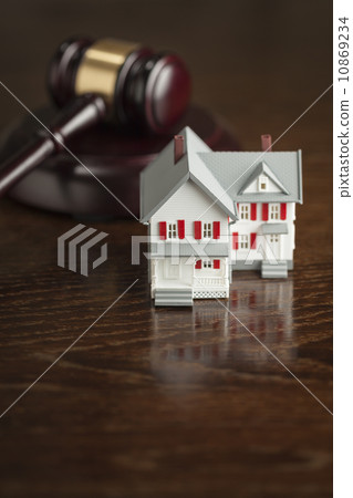 Gavel and Small Model House on Table 10869234